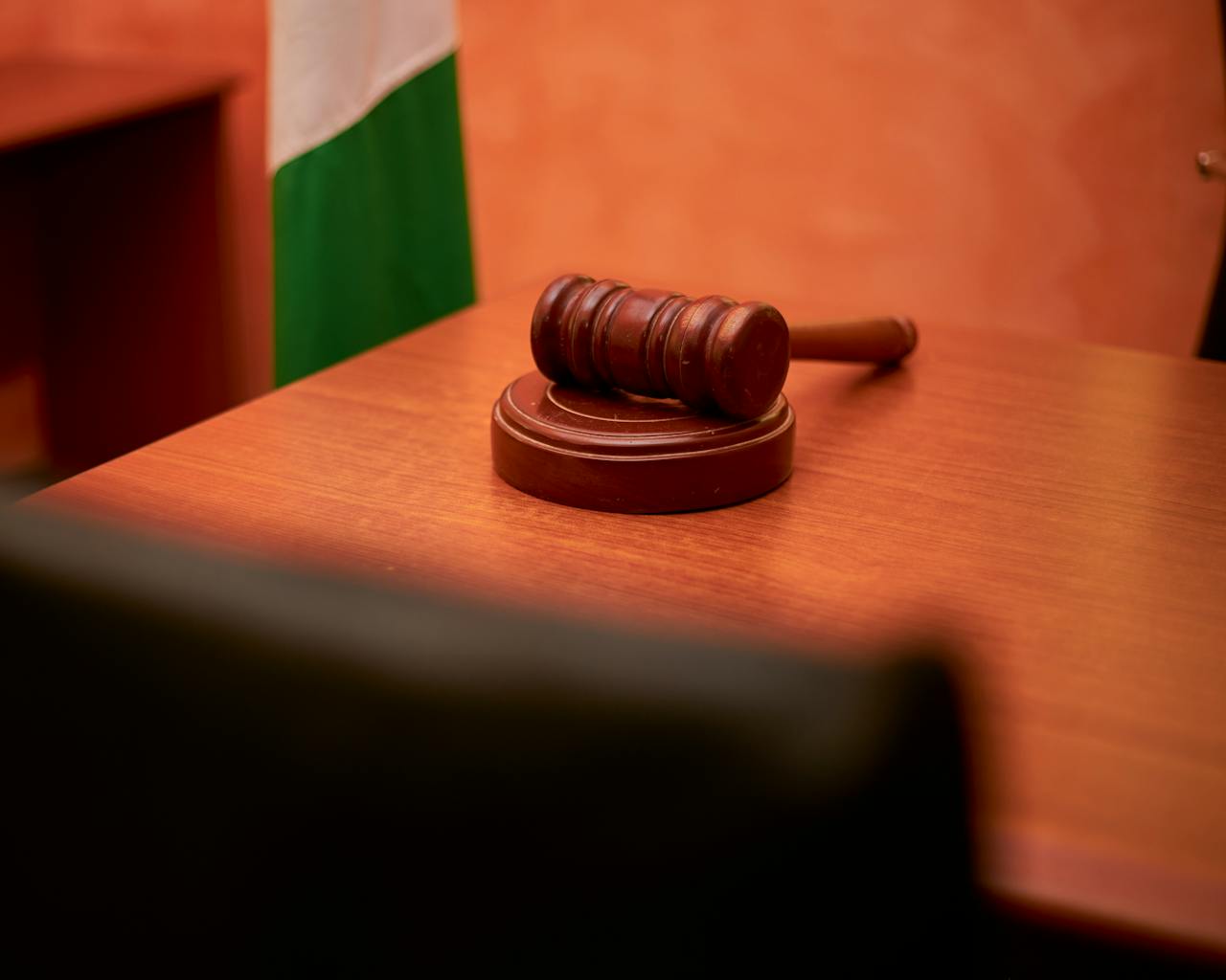 who-we-are A close-up of a gavel on a courtroom desk representing law and justice.